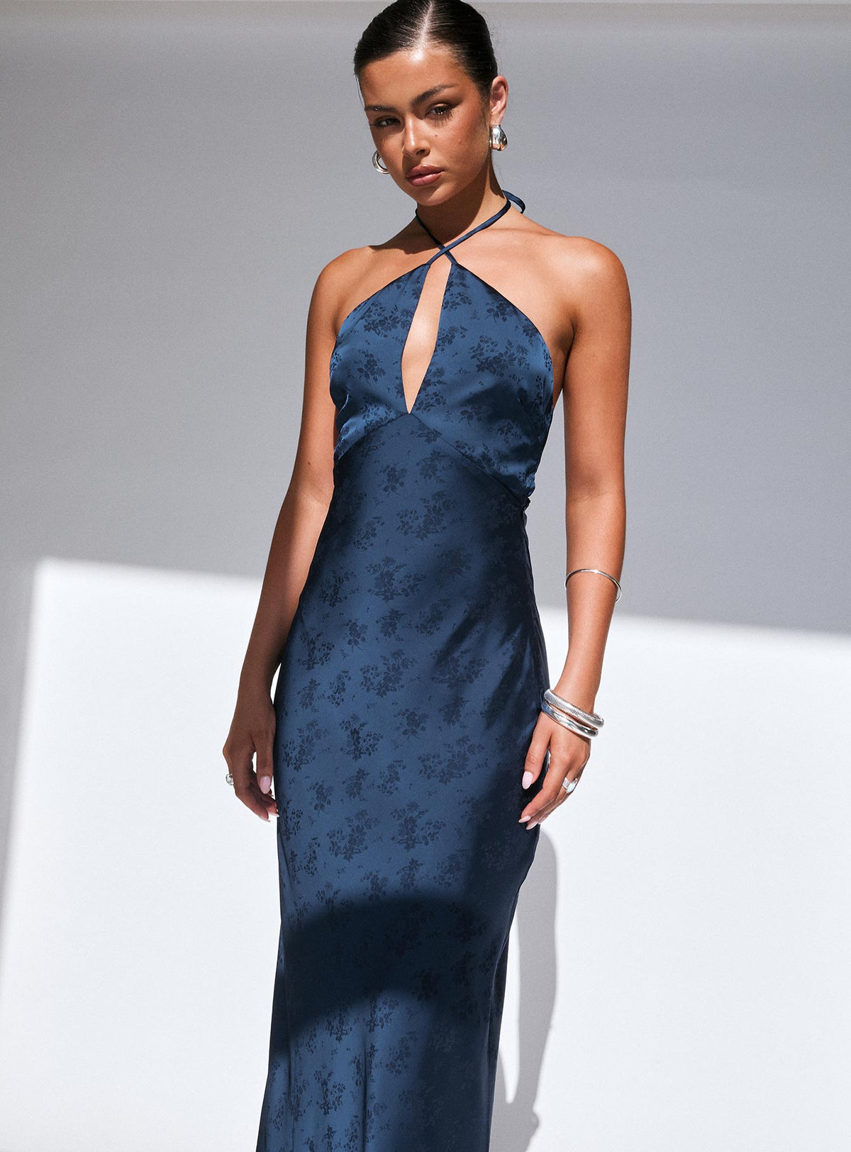 side view of model wearing Princess Polly Limosina Halter Maxi Dress Navy Plunger 