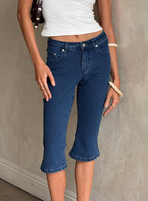 back view of model wearing Princess Polly Kissimo Kick Flare Capri Pants Indigo Blue Mid Rise Jeans Jeans 