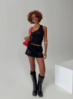 front view of model wearing Princess Polly Amethysta Denim Skort Black Low Rise Shorts 