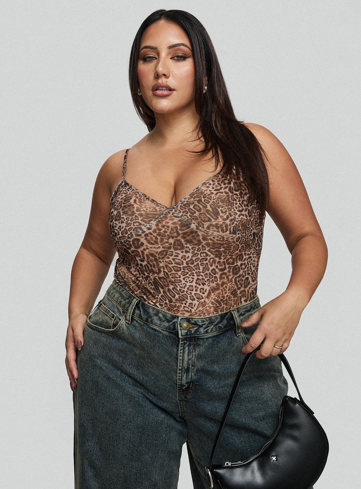side view of model wearing Princess Polly Elixia Bodysuit Leopard Curve Sleeveless Bodysuit 