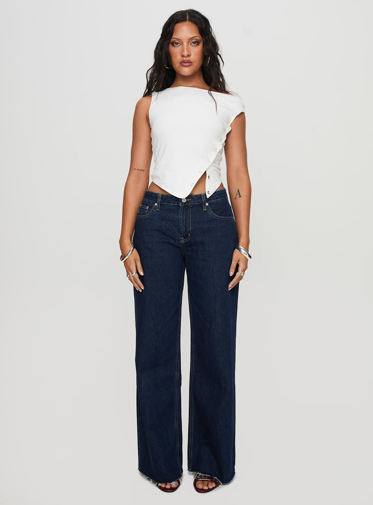 side view of model wearing Princess Polly Darla Low Rise Straight Jean Dark Wash Petite Low Rise Jeans 