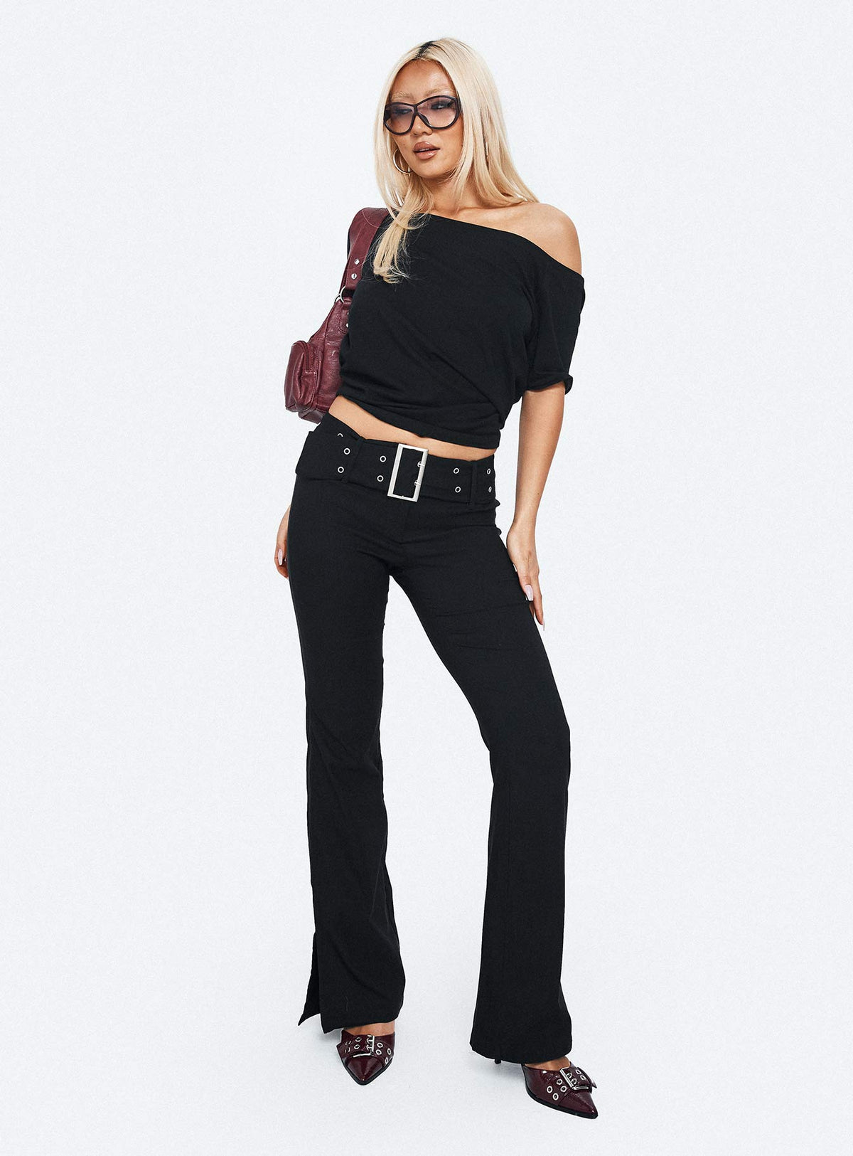 side view of model wearing Princess Polly Kortnee Eyelet Detail Flare Leg Pants Black Low Rise Pants Pants 