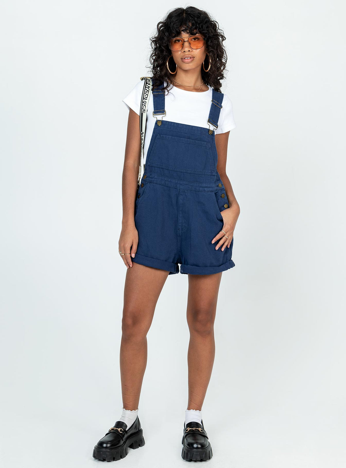 Overalls Denim material Adjustable buckle straps Button fastening at sides Large chest pocket Classic four pockets  Gold-toned hardware  Fixed rolled hem