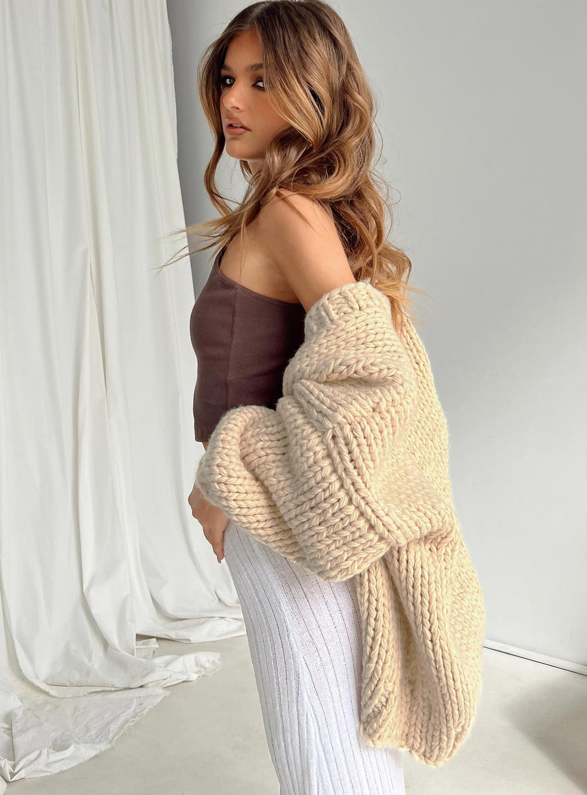 side view of model wearing Princess Polly Lester Knit Cardigan Cream Longline Jumpers Jumpers 