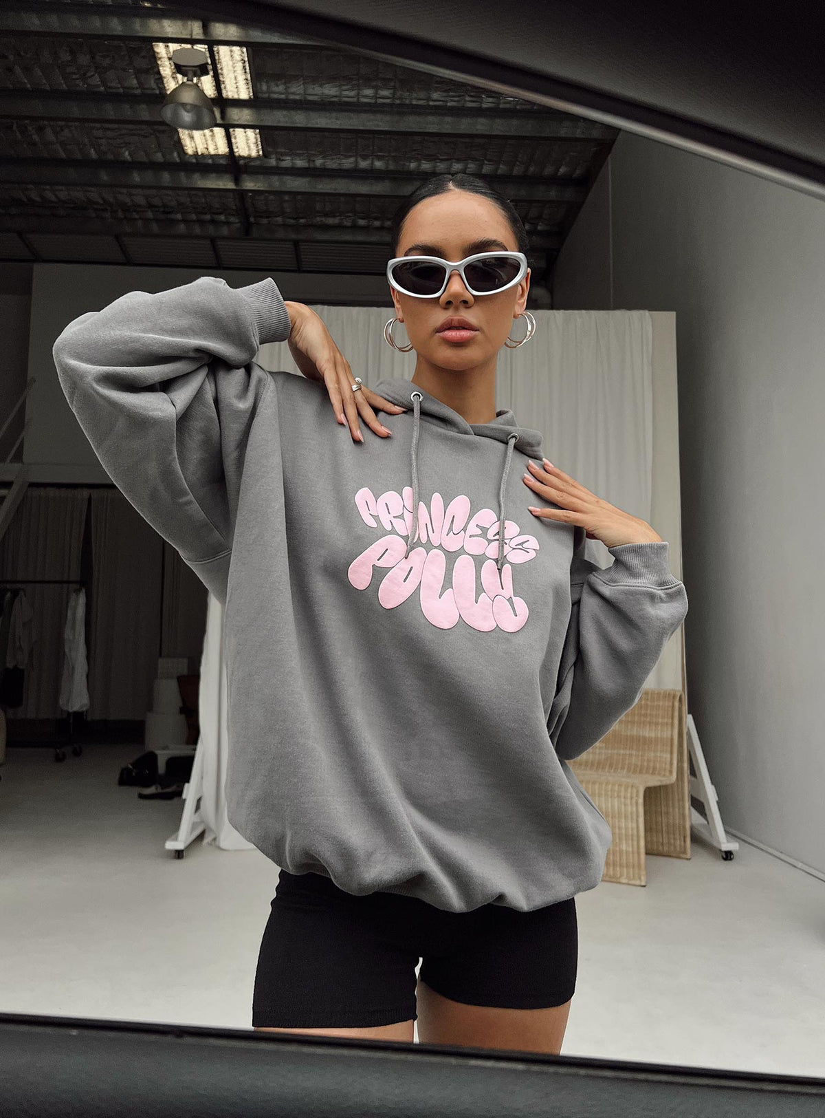 front view of model wearing Princess Polly Princess Polly Hooded Sweatshirt Bubble Text Charcoal / Light Pink Longline Jumpers Jumpers 