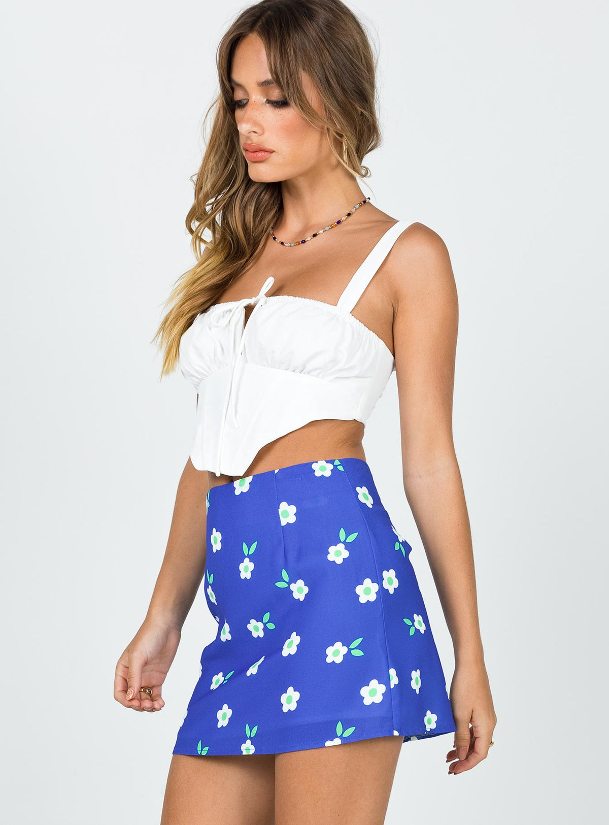   side view of model wearing Princess Polly Selby Mini Skirt Blue Floral Skirts 