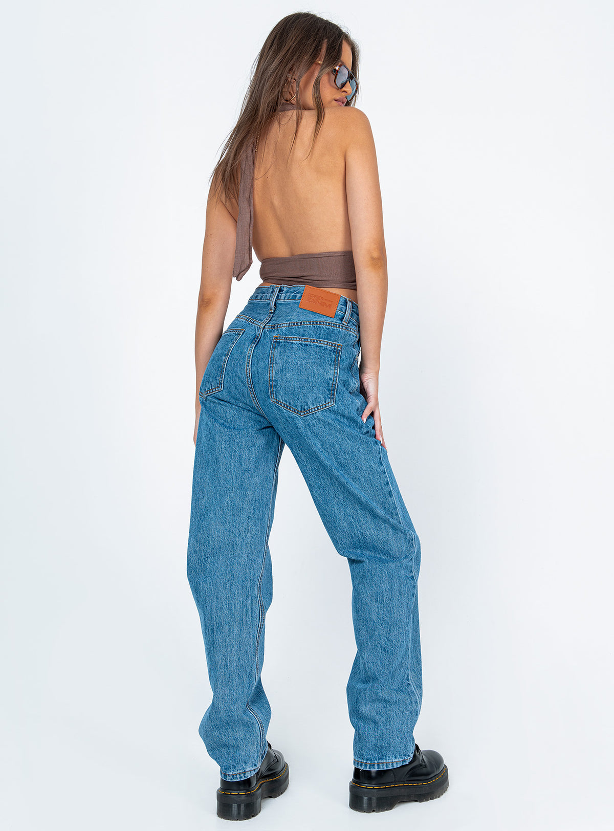 back view of model wearing Princess Polly Holly Asymmetric Straight Leg Jean Mid Wash Denim Mid Rise Jeans Jeans 