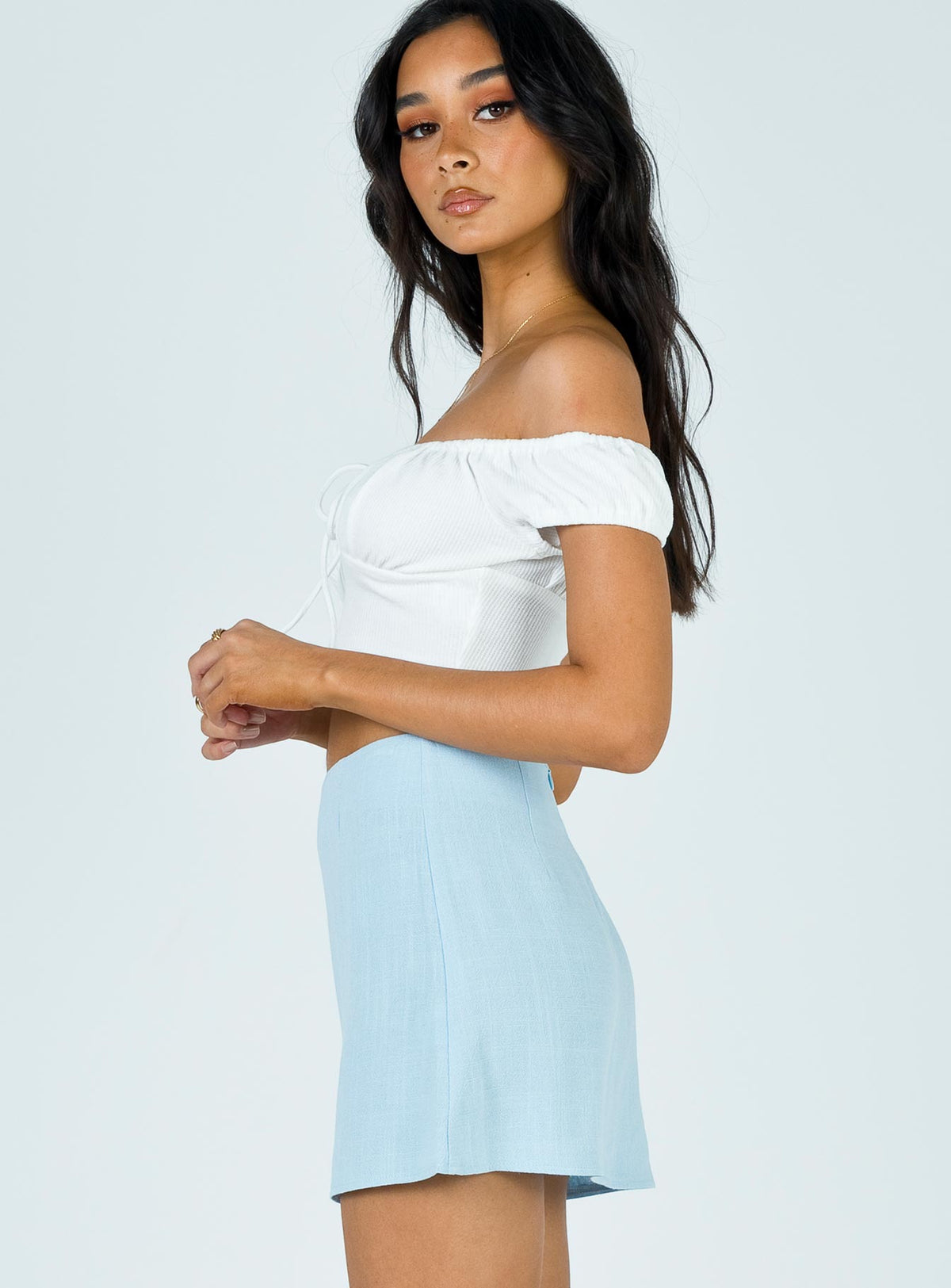   side view of model wearing Princess Polly Selby Mini Skirt Blue Skirts 